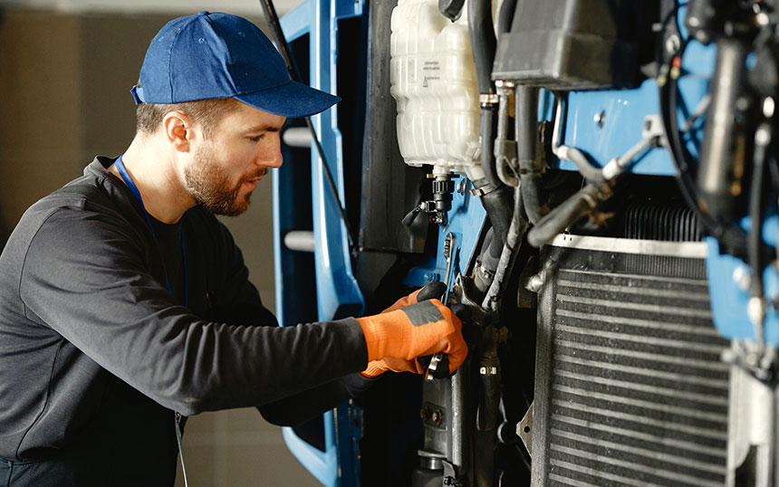 Person Holding Money while working on Calculator Person Holding Money while working on Calculator